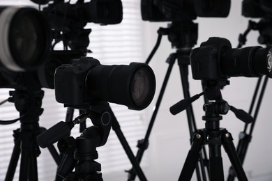 Modern video cameras indoors, closeup. Professional media equipment for broadcasting event