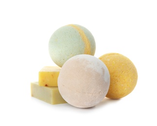 Photo of Bath bombs and soap bars on white background