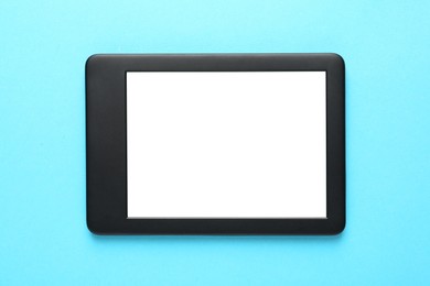 Modern e-book reader with blank screen on turquoise background, top view