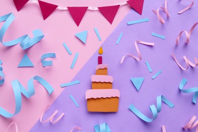 Photo of Birthday party. Paper cake and confetti on color background, flat lay