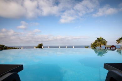 Beautiful landscape with blue sky and infinity pool at resort