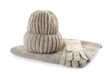 Woolen gloves, hat and scarf on white background. Winter clothes