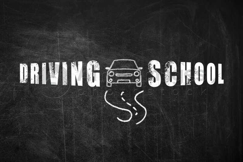 Text Driving School and drawing of car on blackboard