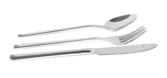New shiny fork and knife on white background