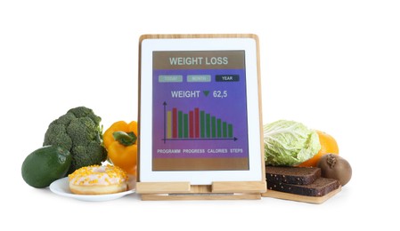 Photo of Tablet with weight loss calculator application and food products on white background