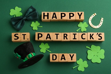 Words Happy St. Patrick's day and festive decor on green background, flat lay