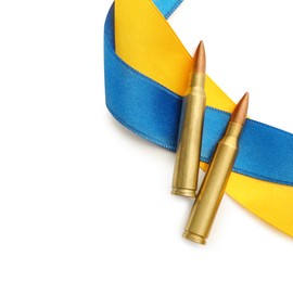 Ribbons in colors of national Ukrainian flag and bullets on white background, flat lay. Space for text