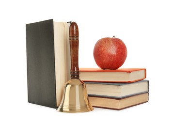 Golden school bell with wooden handle, apple and books on white background