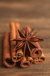Cinnamon sticks with anise on wooden table