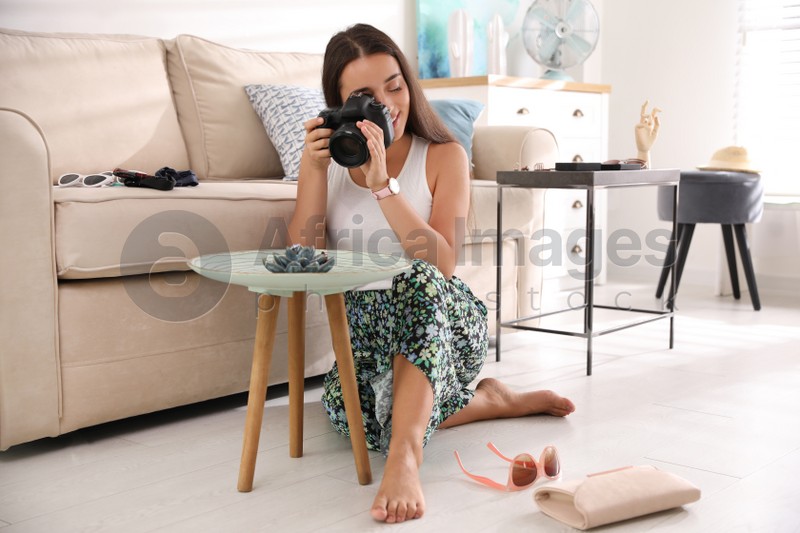 Photo of Young photographer taking picture of jewelry indoors