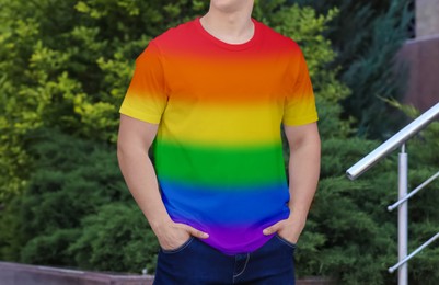 Young man wearing rainbow t-shirt outdoors. LGBT concept