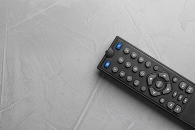 Modern tv remote control on grey table, top view. Space for text