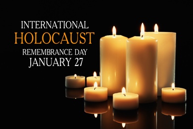 International Holocaust Remembrance Day January  27. Different wax candles burning on table in darkness