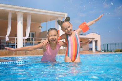 Cute little girls in swimming pool at water park