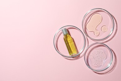Photo of Many Petri dishes and cosmetic products on pink background, flat lay. Space for text