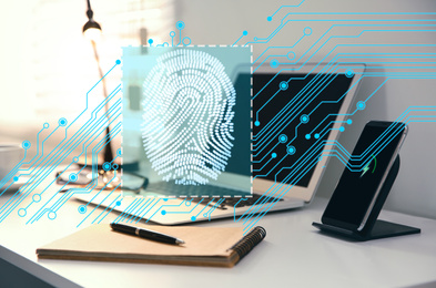 Fingerprint identification. Modern laptop and smartphone on table indoors