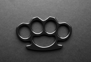 Brass knuckles on black background, top view