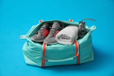 Sports bag with gym stuff on blue background