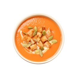 Tasty creamy pumpkin soup with croutons and seeds in bowl on white background, top view