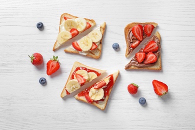 Tasty toast bread with banana and strawberry on light background