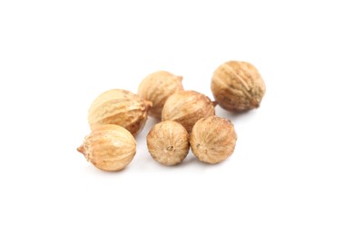 Photo of Scattered dried coriander seeds on white background, closeup