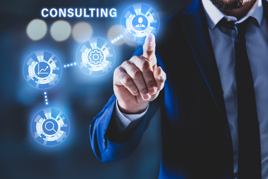 Consulting concept. Businessman pointing on dark background, closeup