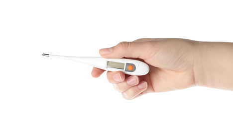 Photo of Woman holding digital thermometer on white background, closeup