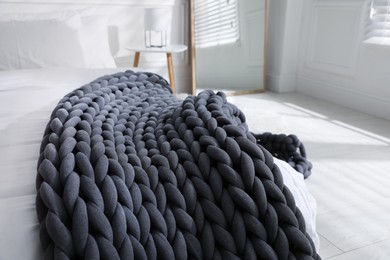 Photo of Soft chunky knit blanket on bed indoors