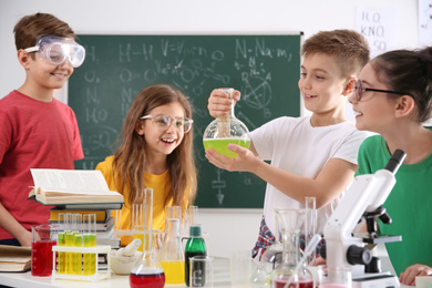 Smart pupils making experiment in chemistry class