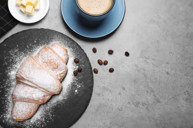 Flat lay composition with tasty croissant on grey table, space for text