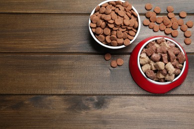 Wet and dry pet food on wooden table, flat lay. Space for text