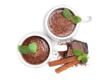 Photo of Cups of delicious hot chocolate with mint and cinnamon sticks on white background, top view