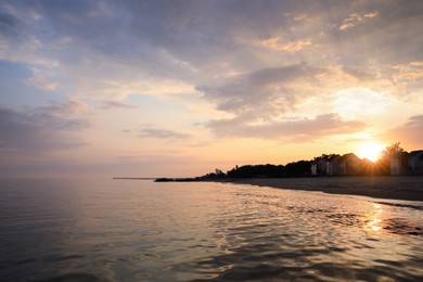 Photo of Picturesque view of sea and coast at sunset