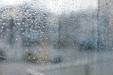 Closeup view of foggy window with rain drops