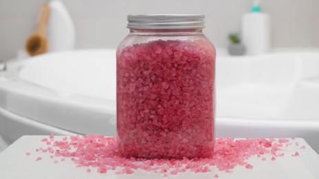 Jar with bath salt on table in bathroom, closeup
