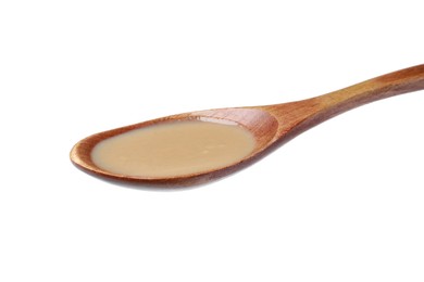 Spoon of tasty sesame paste isolated on white