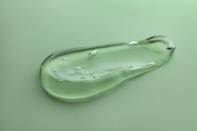 Photo of Sample of transparent gel on green background