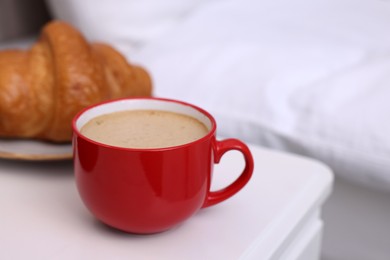 Photo of Morning coffee and croissant on white table, closeup. Space for text