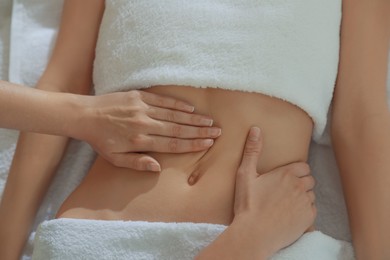 Woman receiving professional belly massage, closeup view