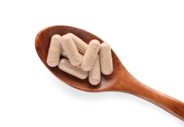 Gelatin capsules in spoon on white background, top view