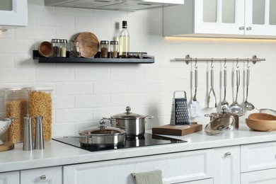 Countertop with different cooking utensils in kitchen