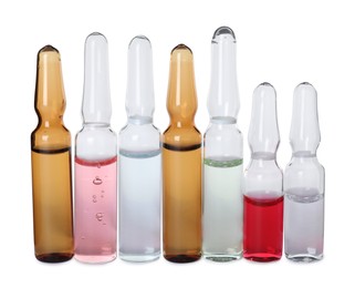 Glass ampoules with pharmaceutical products on white background