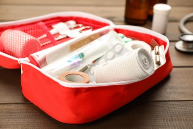 First aid kit on wooden table, closeup