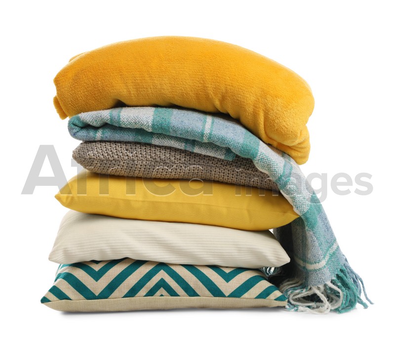 Photo of Stylish soft pillows and blankets on white background