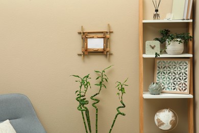 Stylish room interior with bamboo frame and shelving unit