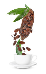 Cocoa pod and beans falling into cup on white background 