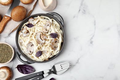 Photo of Delicious pasta with mushrooms served on white table, flat lay. Space for text