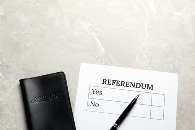 Referendum ballot with pen and passport on light grey marble table, flat lay. Space for text