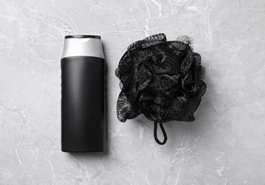 Photo of Bottle of shower gel and bast wisp on light grey marble background, flat lay. Men's cosmetics