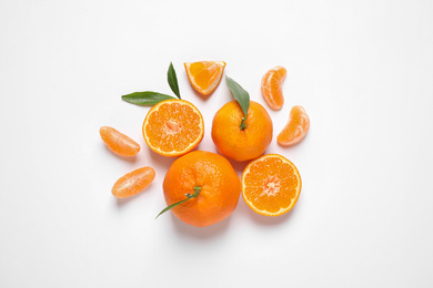 Composition with fresh ripe tangerines and leaves on white background, flat lay. Citrus fruit